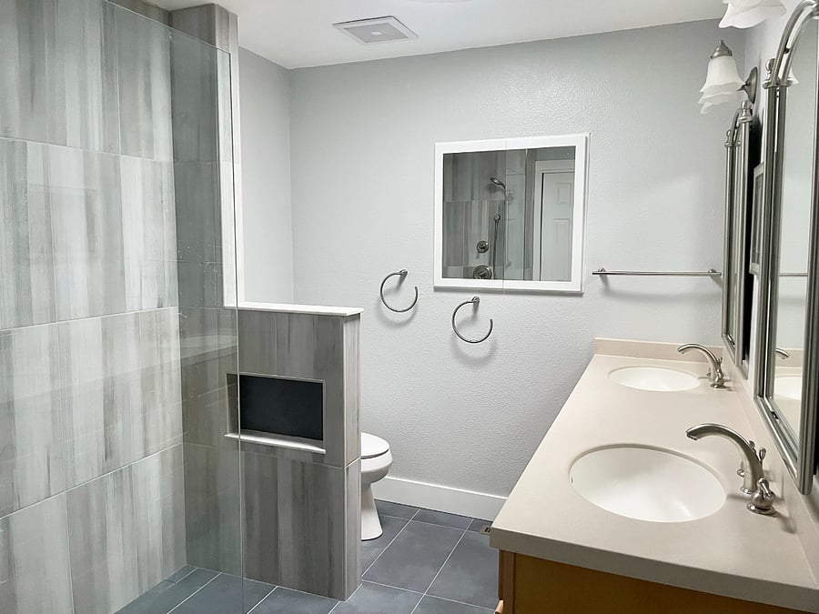Bath 1: Primary Bath with heated floors, double vanity, curb-less shower entry, rain shower, large medicine cabinet, and closet.