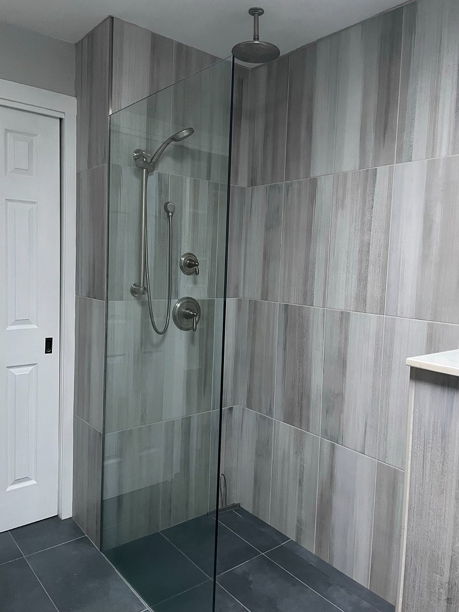 Bath 1: Primary Bath with heated floors, double vanity, curb-less shower entry, rain shower, large medicine cabinet, and closet.