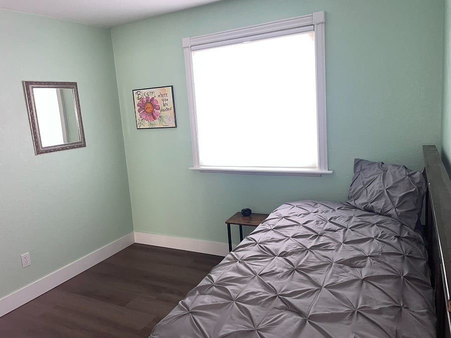 Bedroom 4: Downstairs bedroom with twin bed. Storage drawers in bed and closet. 