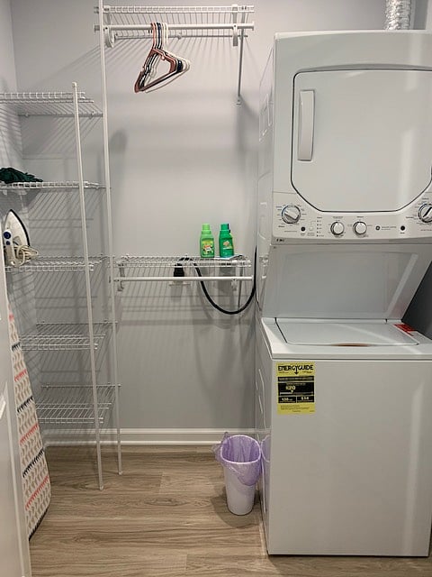 In suite washer and dryer closet. Ironing board and iron. Shelving, hanging rods, and umbrella.