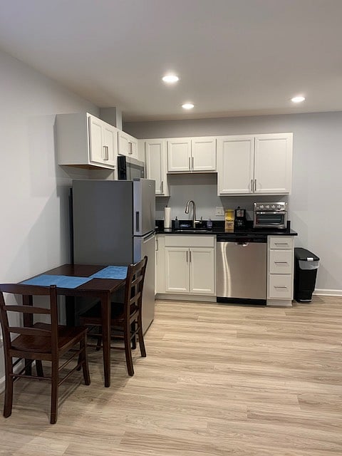 Dining table that can be used for remote workspace. Kitchenette with new stainless-steel appliances.