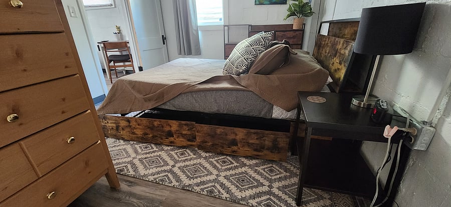Each side of the bed has two drawers below that are on wheels.