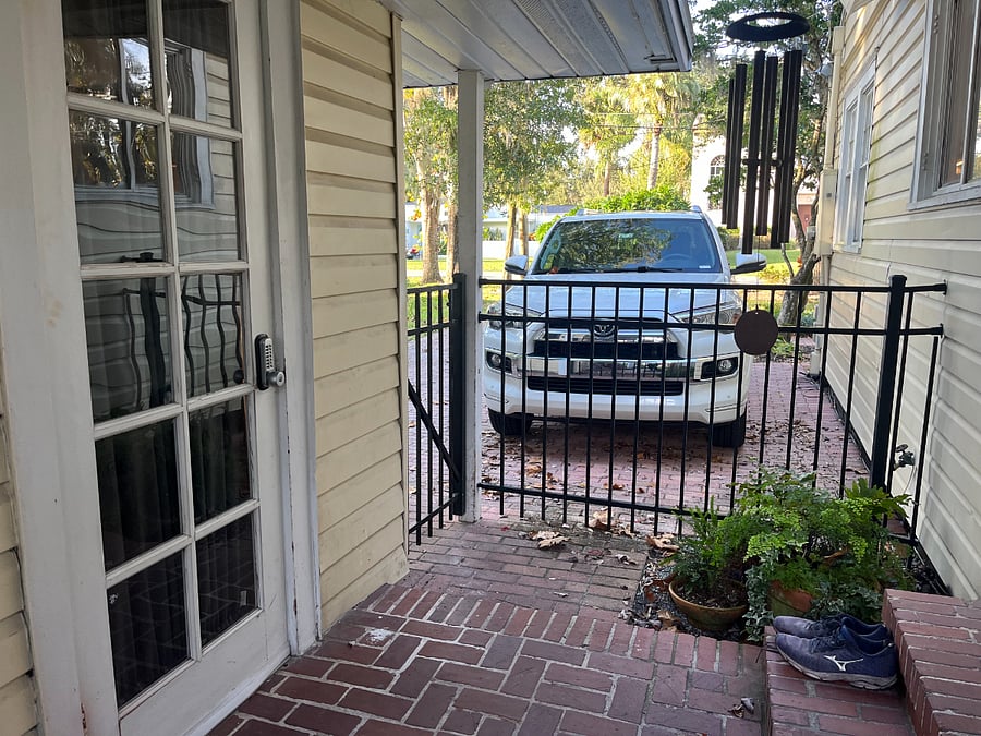 Cottage entrance on the left, main house on the right, looking towards the driveway where off-street parking is provided.