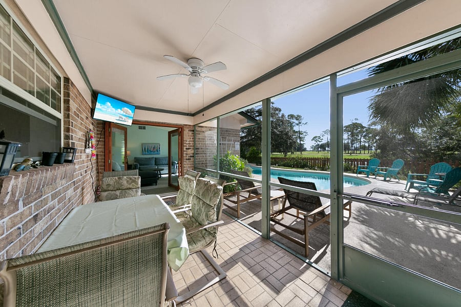 Step out from the living room or kitchen into the screened-in porch equipped with a ceiling fan and TV while letting the kids enjoy the pool