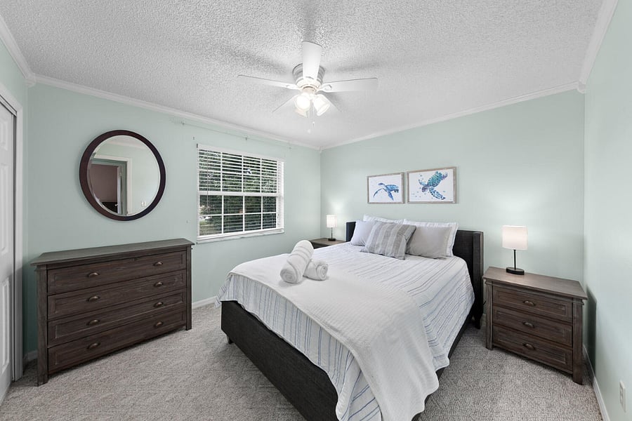 First guest bedroom with a queen bed and clean sheets. Outlets for charging are next to all the beds.