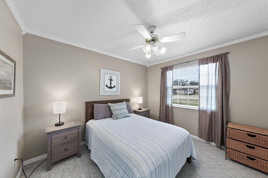 Third bedroom with full sized bed and overhead fan for added comfort