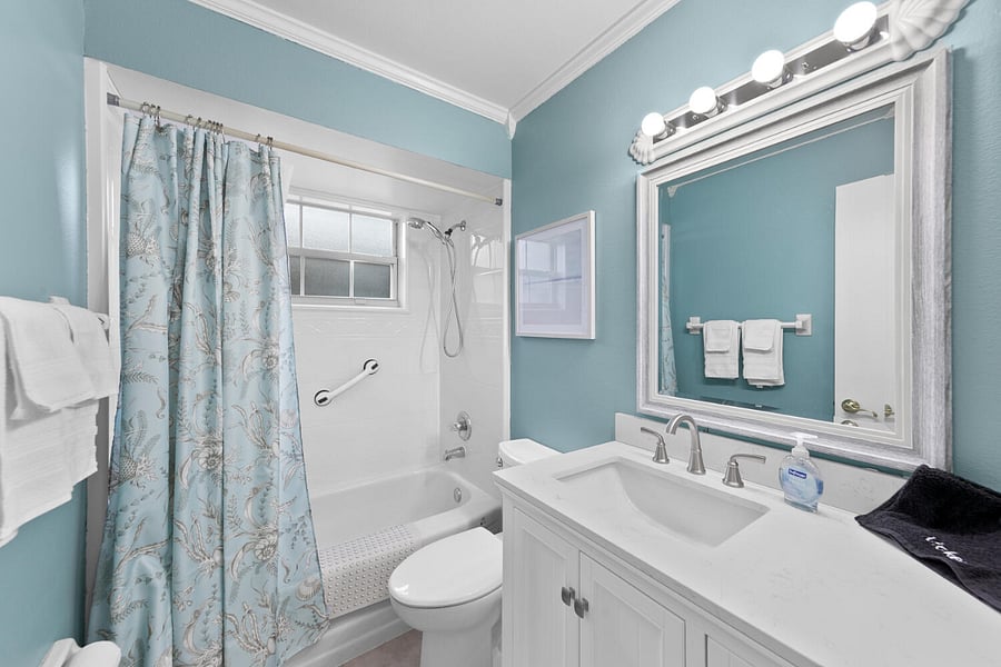 Guest bathroom with another Bath Fitter shower adorned with new quartz vanity