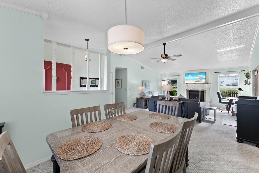 Kitchen area leads into open concept living room and dining room. Dining room table with seats for six, and extra leaves to expand the table.