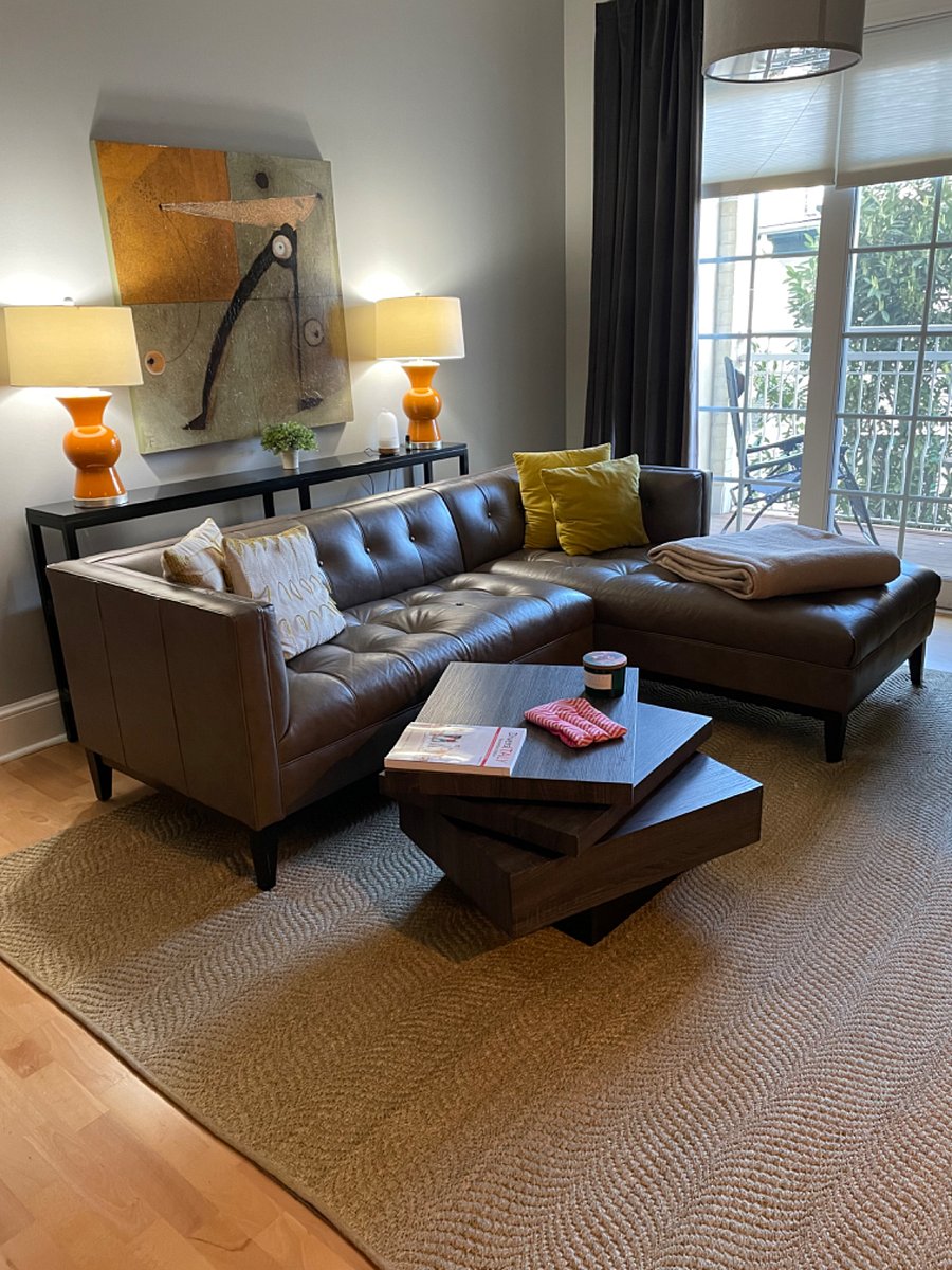 Living room with leather sofa and extender which can be used as a bed