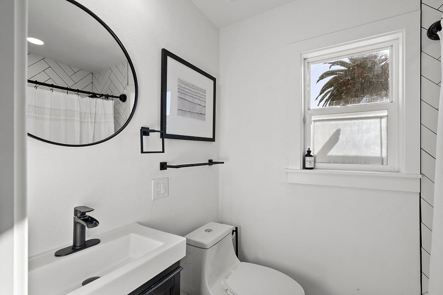 Ensuite Bathroom to the Primary Bedroom.  It has a tub with a shower in it. 