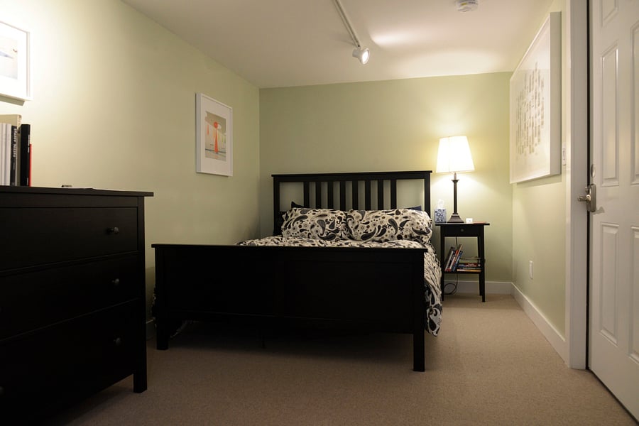 Comfortable queen bed with nightstand and bureau.