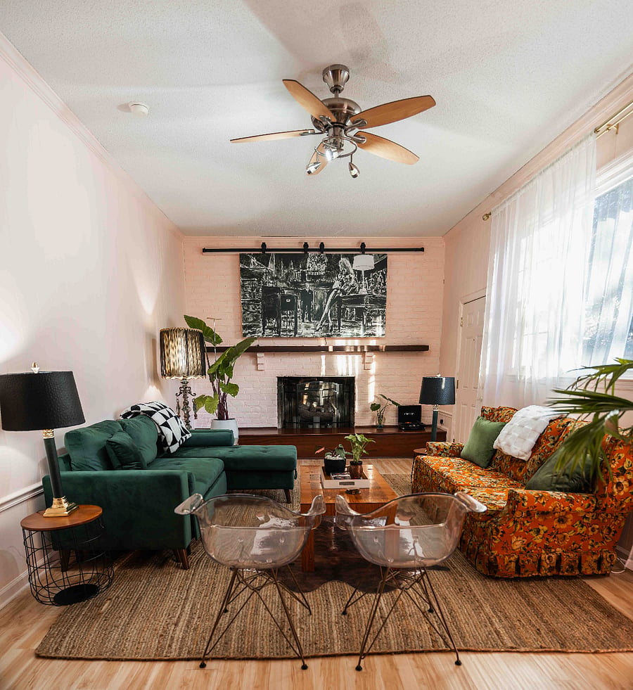 Massive living room/den, 67-inch smart TV hidden behind art installation for when you want a more analog evening.