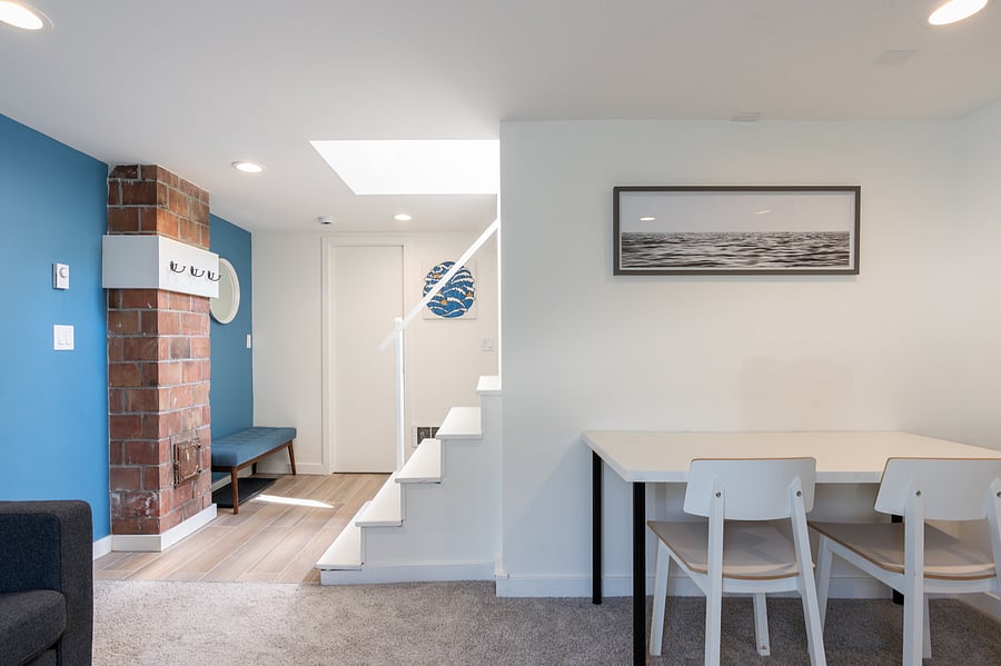 View from living room towards bathroom and entry stairs.