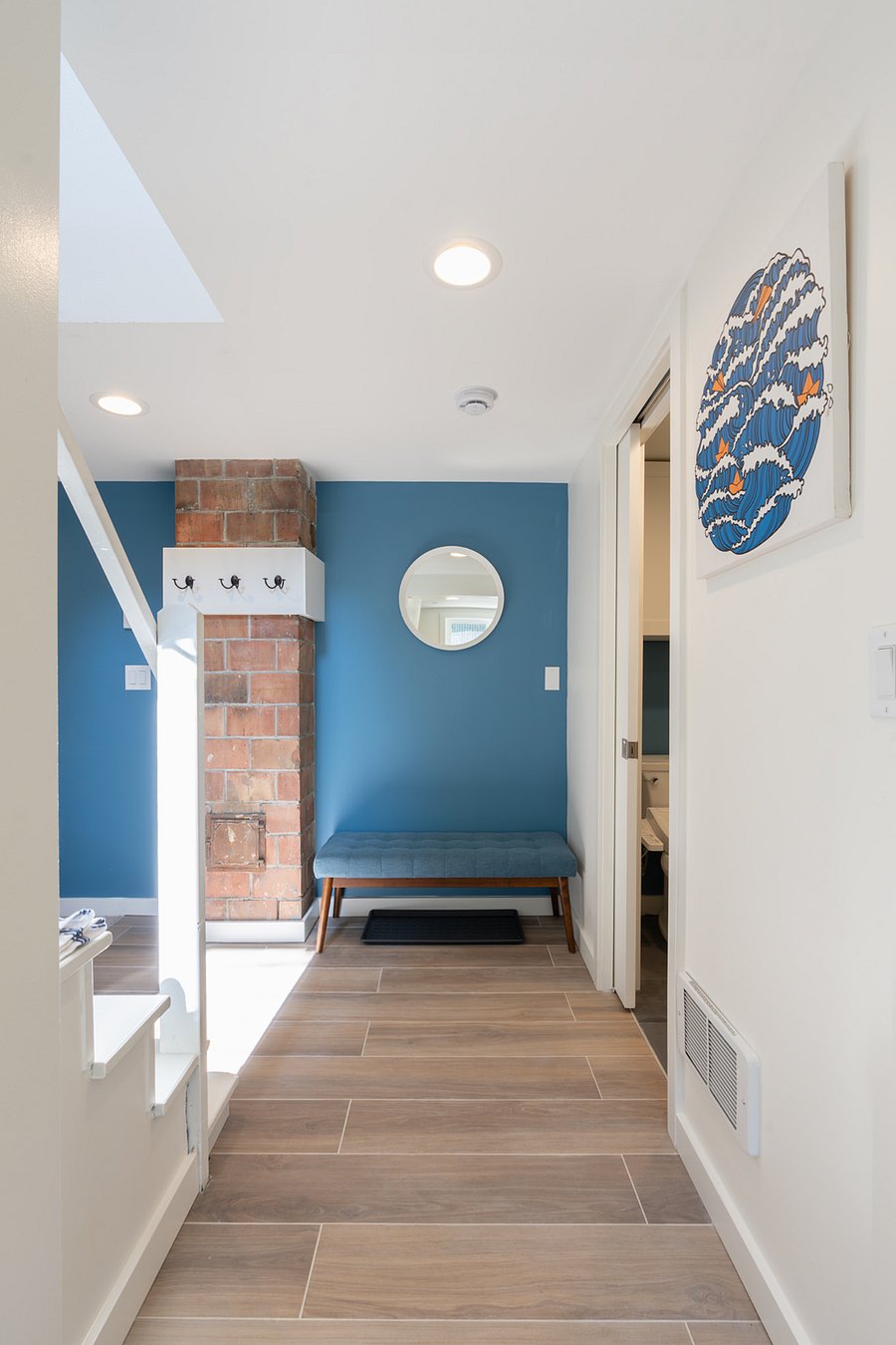 View of entryway and coat or dog leash hooks.