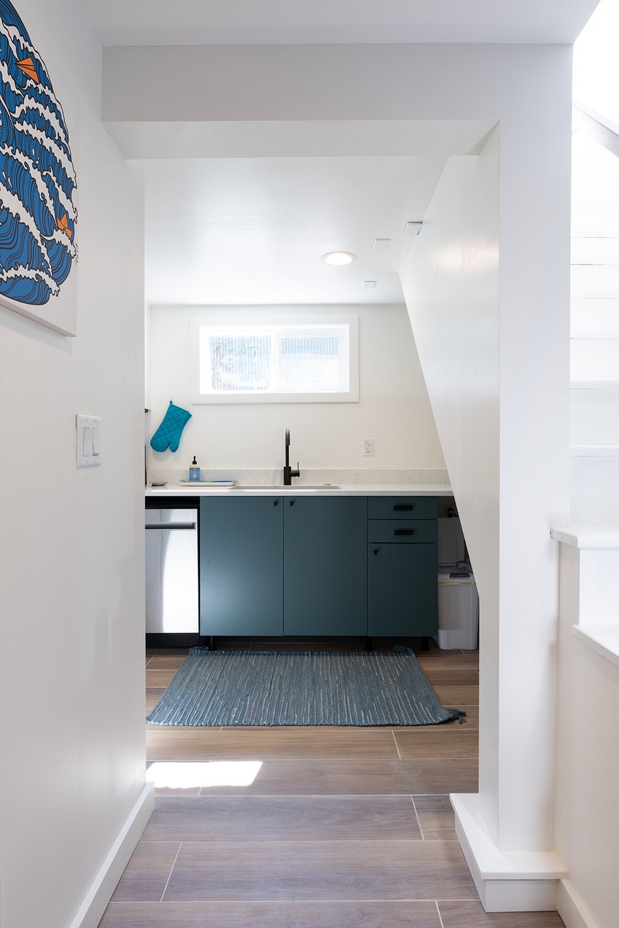 Enter the kitchen from landing at the base of entry stairs.