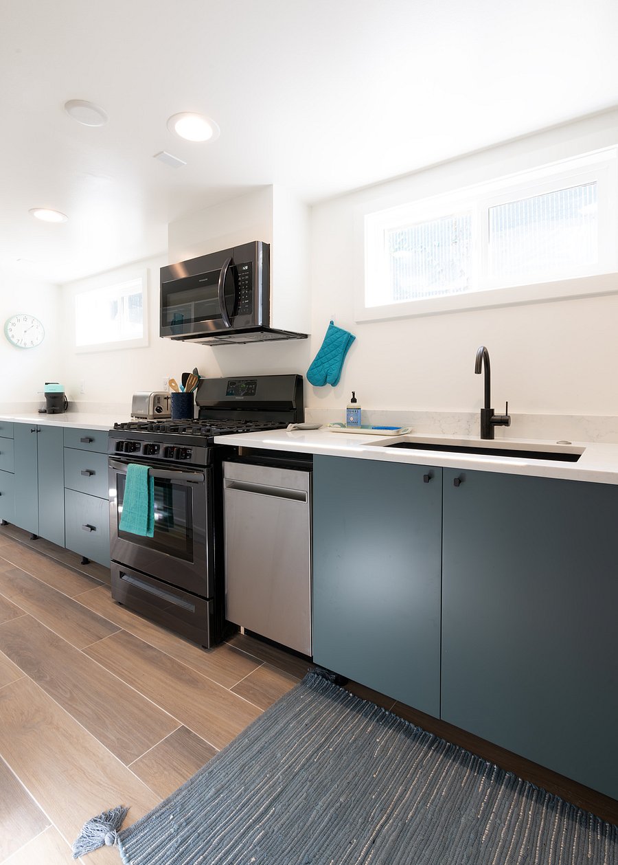 Light and bright kitchen has apartment sized dishwasher, toaster, Nespresso Vertuo machine.