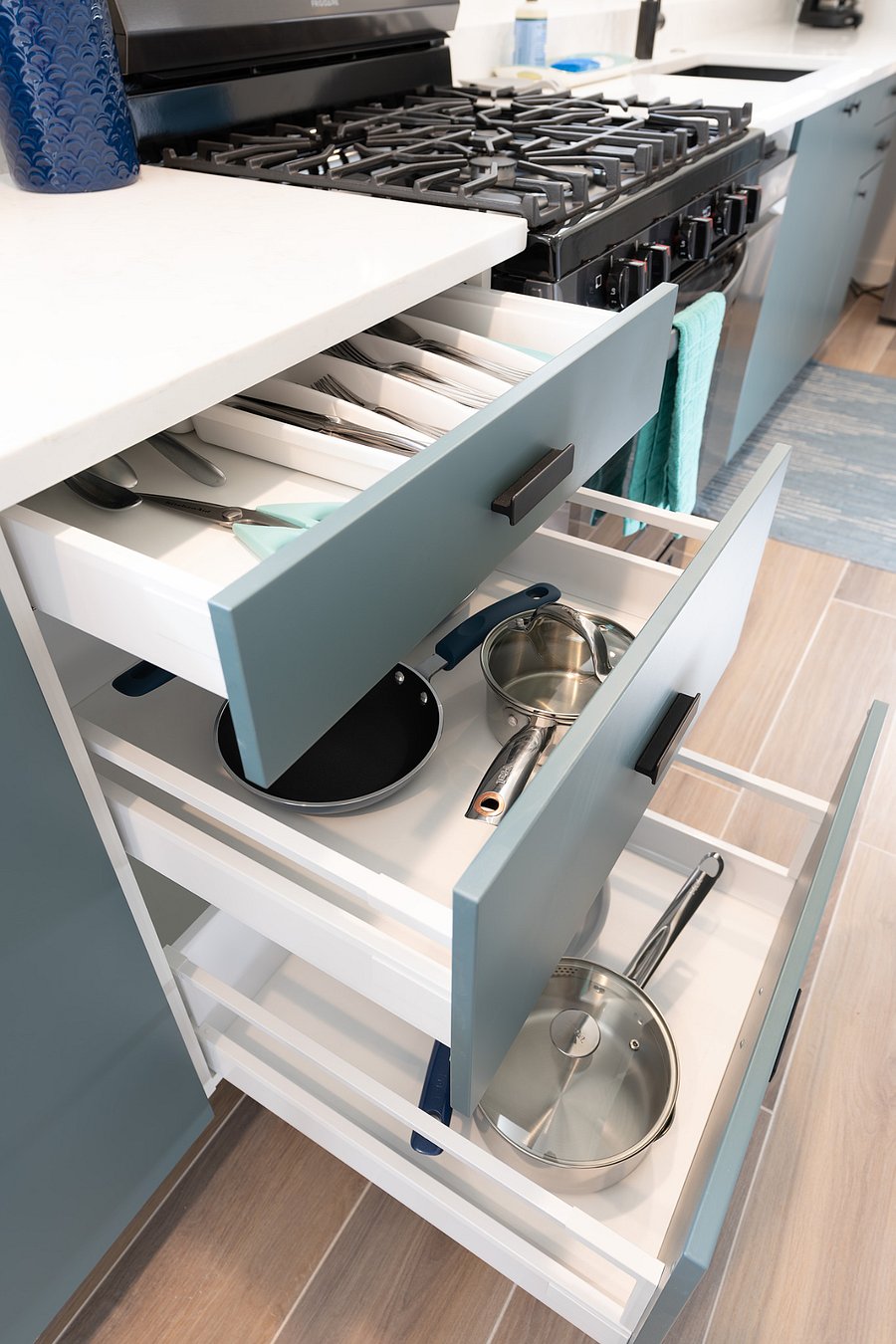 Kitchen is stocked with cooking utensils and equipment.
