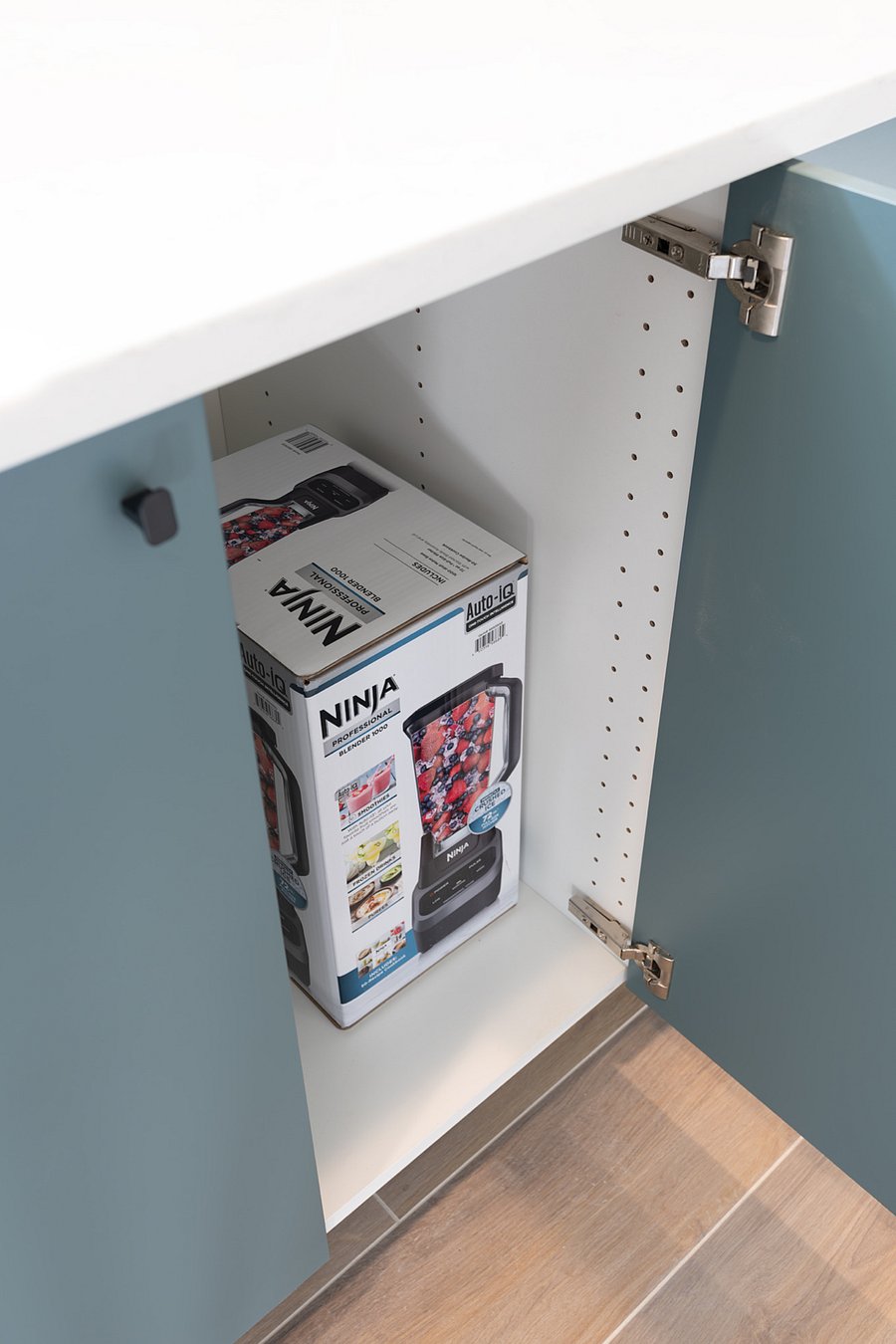 Ninja blender in unit. Deep cabinets for storage.