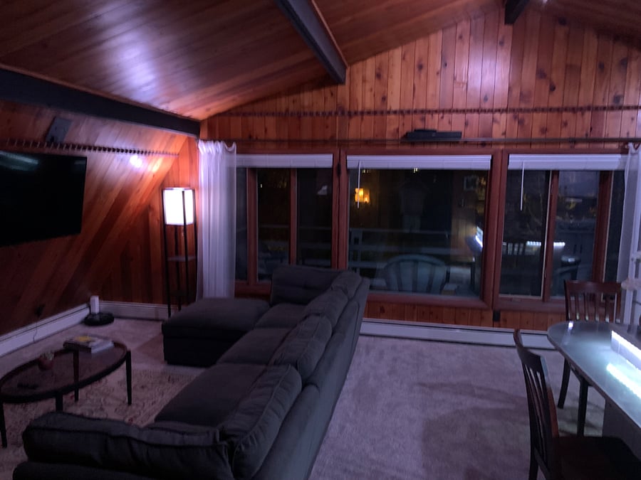 Fully furnished living space with ample ambient lighting all controlled with smart home software