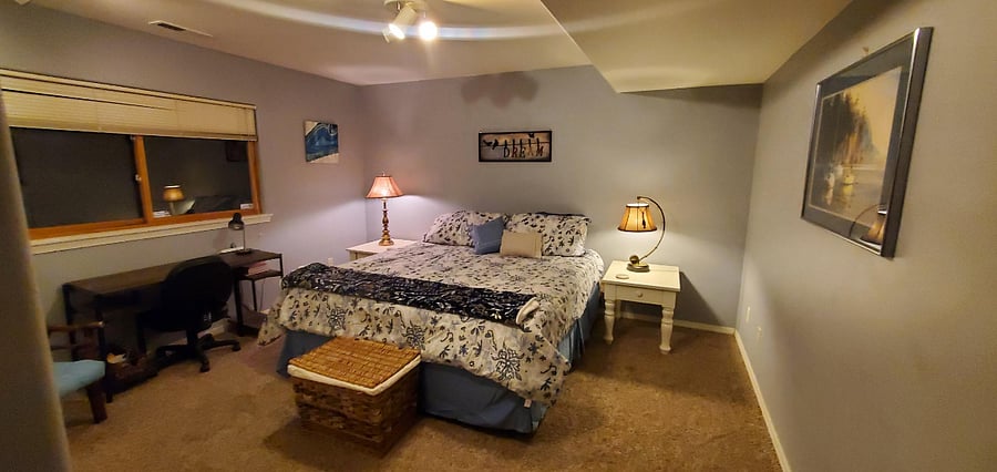 Over sized bedroom with king bed, dresser and desk