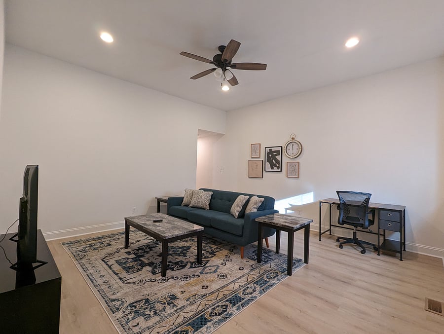 A cozy living room while watching your favorite TV show or movie with dedicated work space!