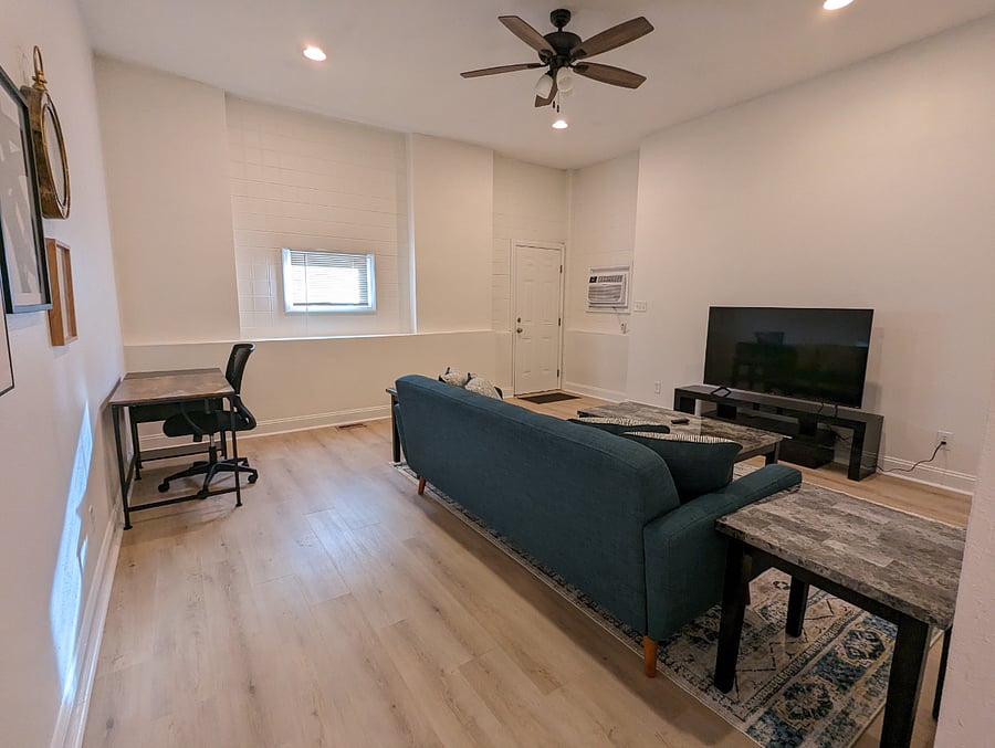 A cozy living room while watching your favorite TV show or movie with dedicated work space!