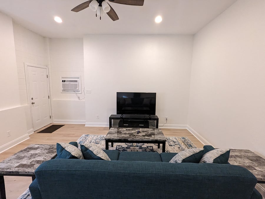 A cozy living room while watching your favorite TV show or movie with dedicated work space!