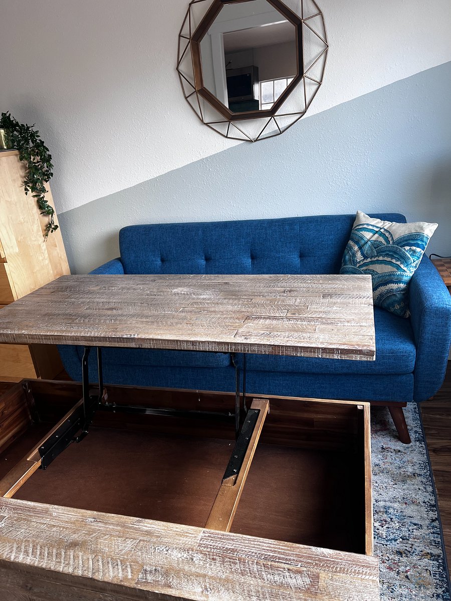 Lift top coffee table for storage, dining, and work.