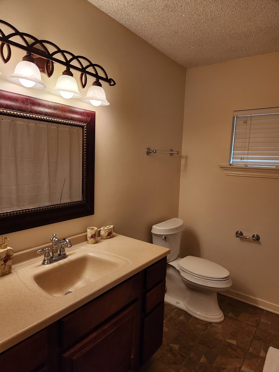 Guest full bathroom with linen closet.