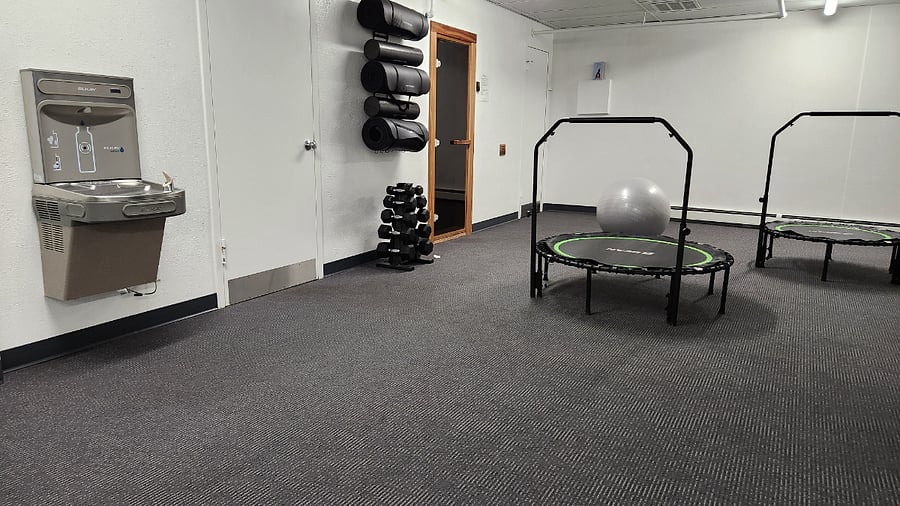 Stretch room, dry sauna and 2 bathrooms in the basement below the fitness center.