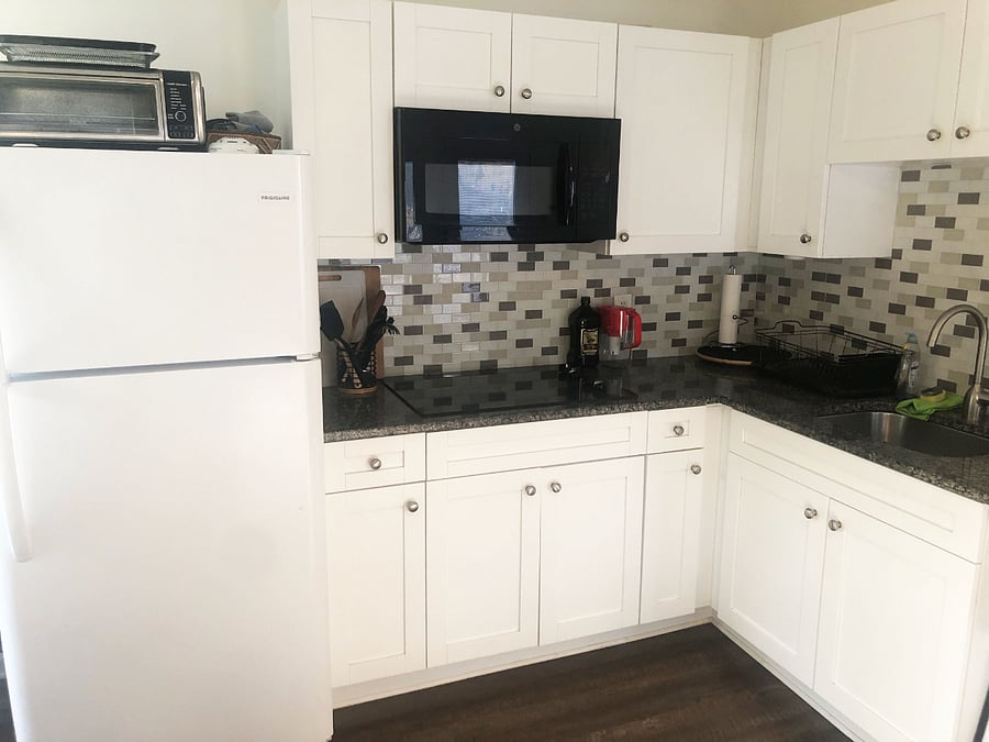 kitchen is fully stocked with microwave, cook top, toaster oven, toaster and coffee machine