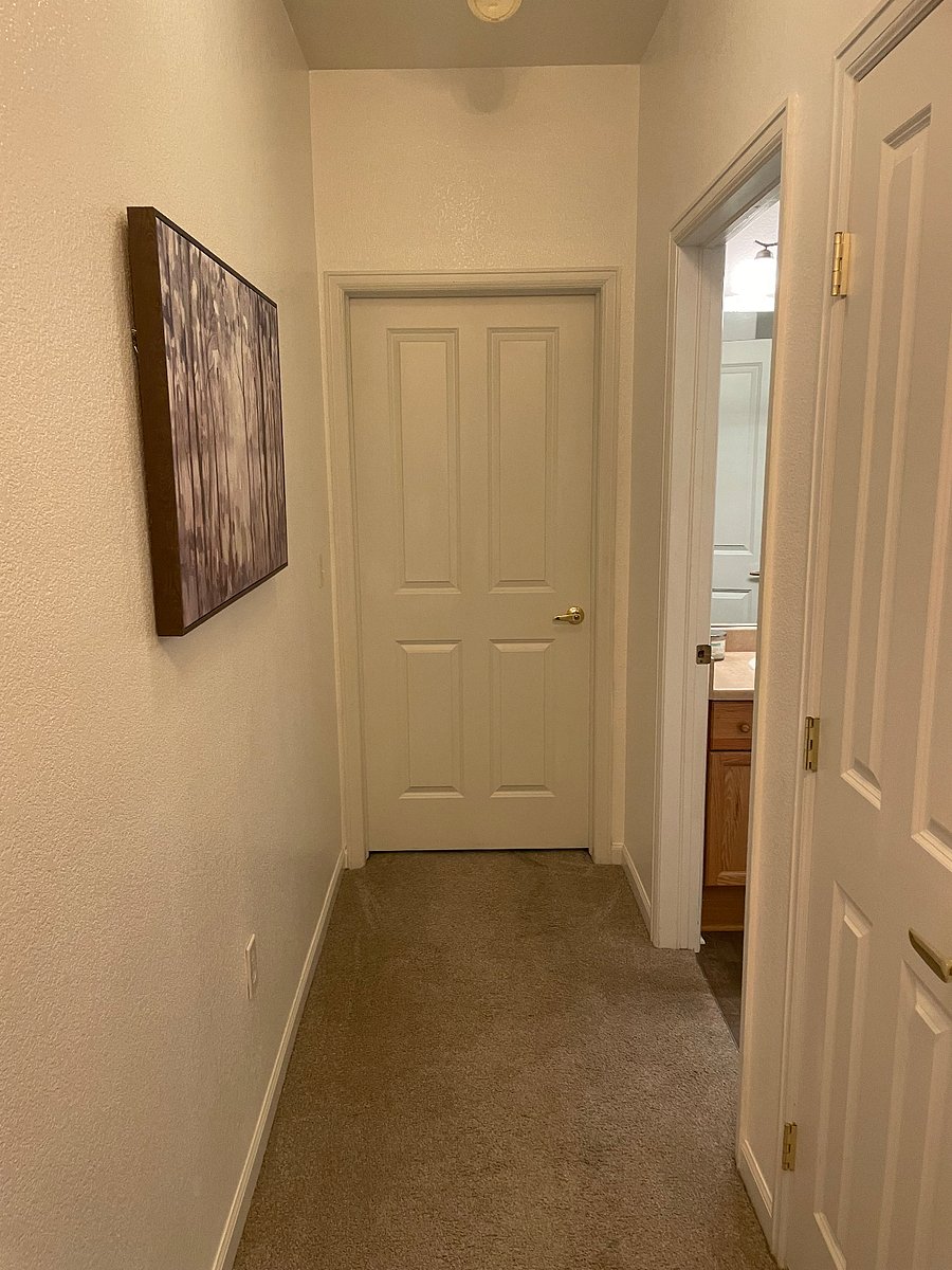 Hallway to 2nd bedroom with closet on left side