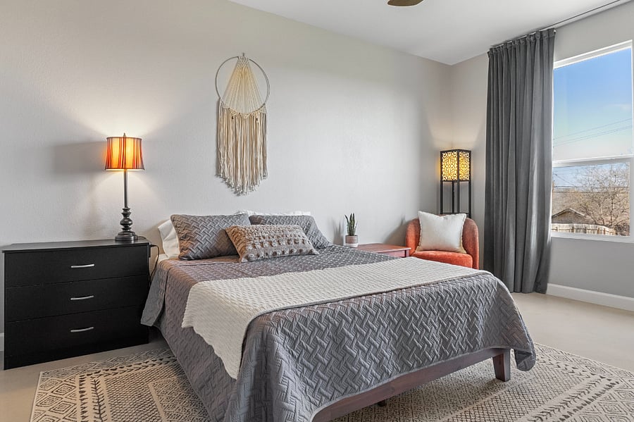 Master bedroom with queen size bed and fully equipped with smart TV, desk, reading area, walk-in closet and private bathroom.