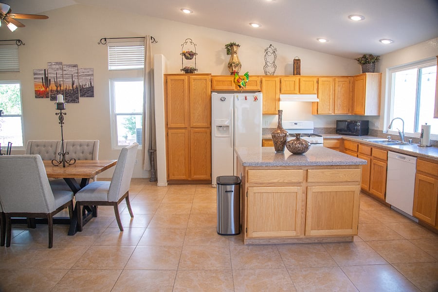 Another view of the bright and airy kitchen, with granite counters and all appliances, utensils, dishes, etc!