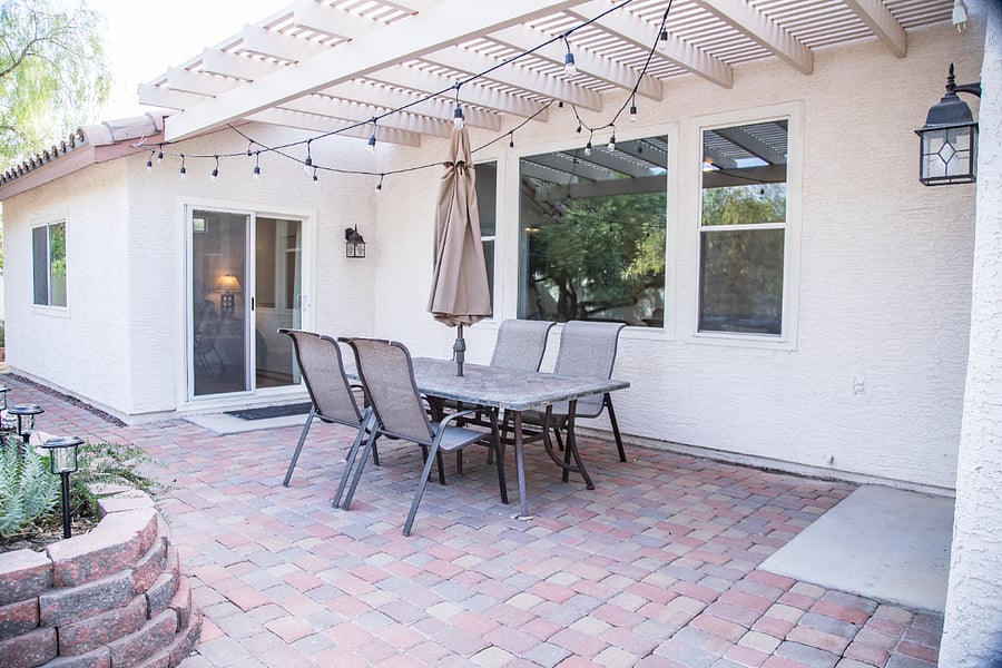 The patio has a table and umbrella for outdoor living.