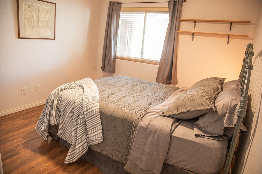 This spare bedroom on the west side of the house gets afternoon and evening sunlight. Black-out curtains if you're a day sleeper. A TV was installed since this photo was taken.