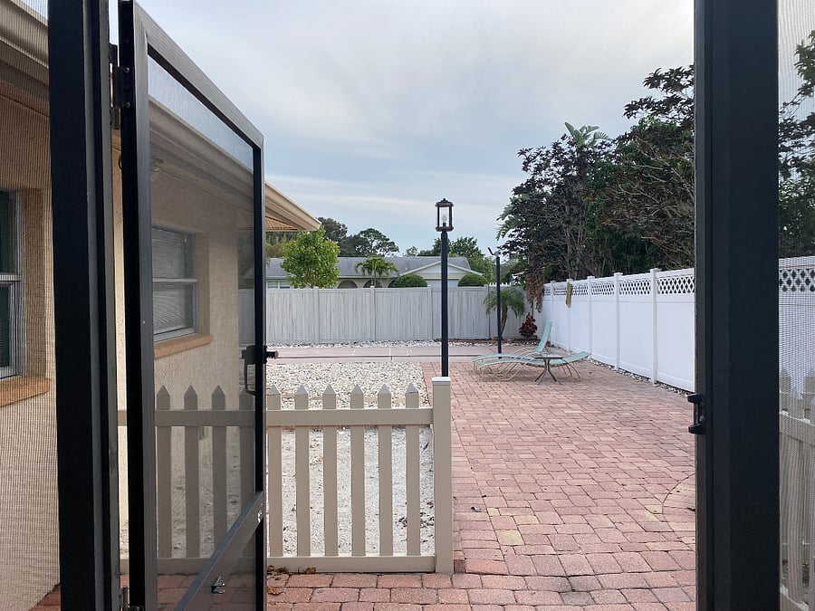 Large, completely enclosed  back yard lounge area with privacy fence.