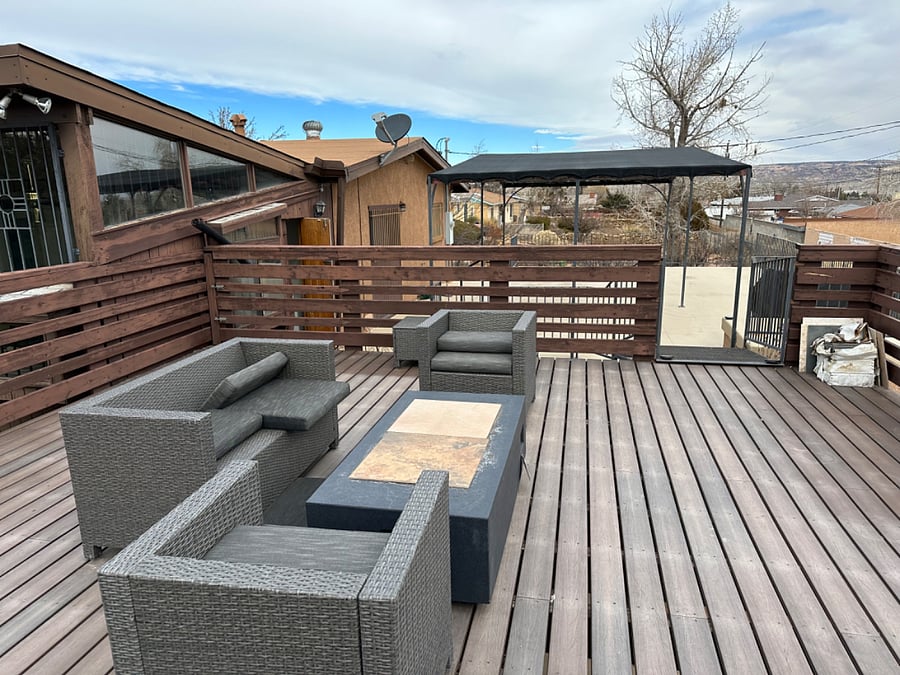 Outdoor patio seating with natural gas fire-pit.