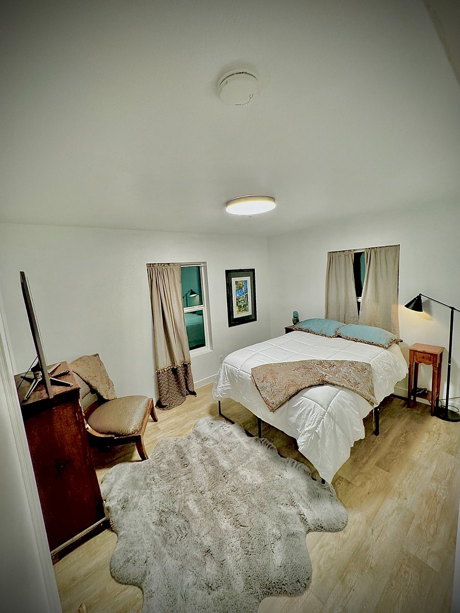 1st bedroom with queen size bed, two closets and tv.