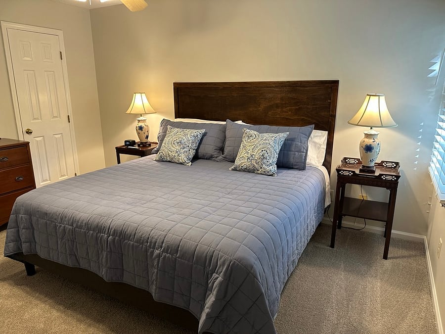first bedroom with TV, walk in closet and en suite bathroom.