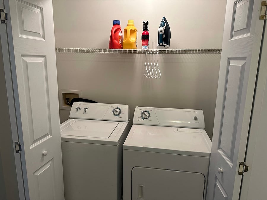 upstairs washer, dryer, ironing board, iron, fire extinguisher.