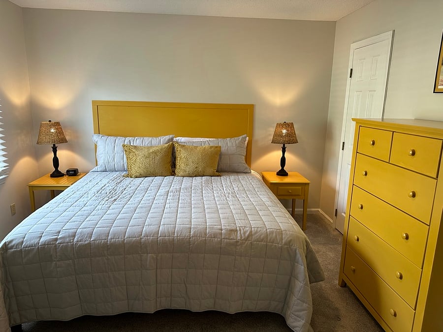 second bedroom with desk, chair, walk in closet, and en suite bathroom with bathtub / shower