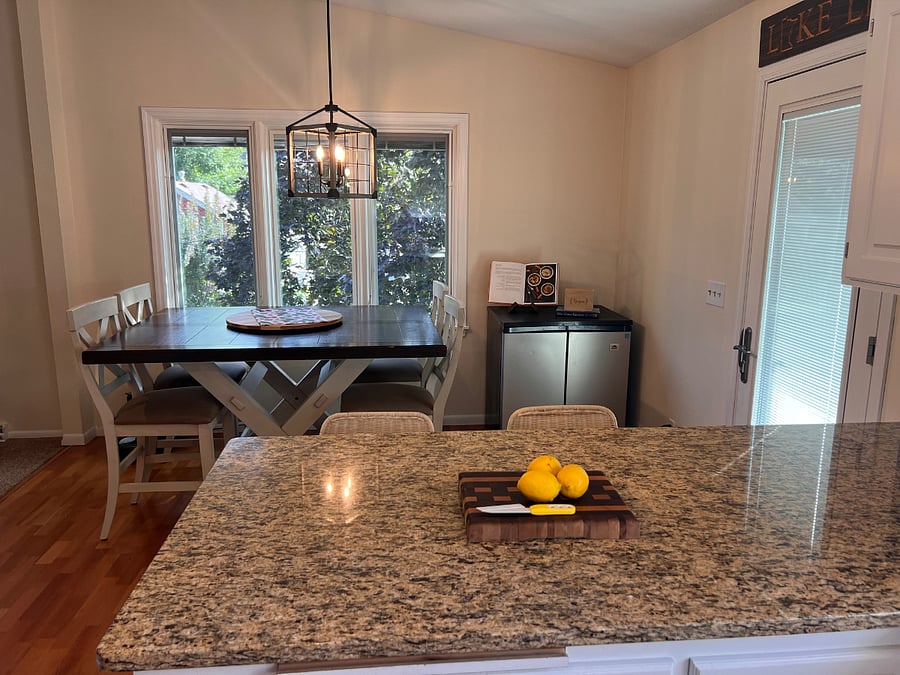 Kitchen opens to dining room and serene surroundings.