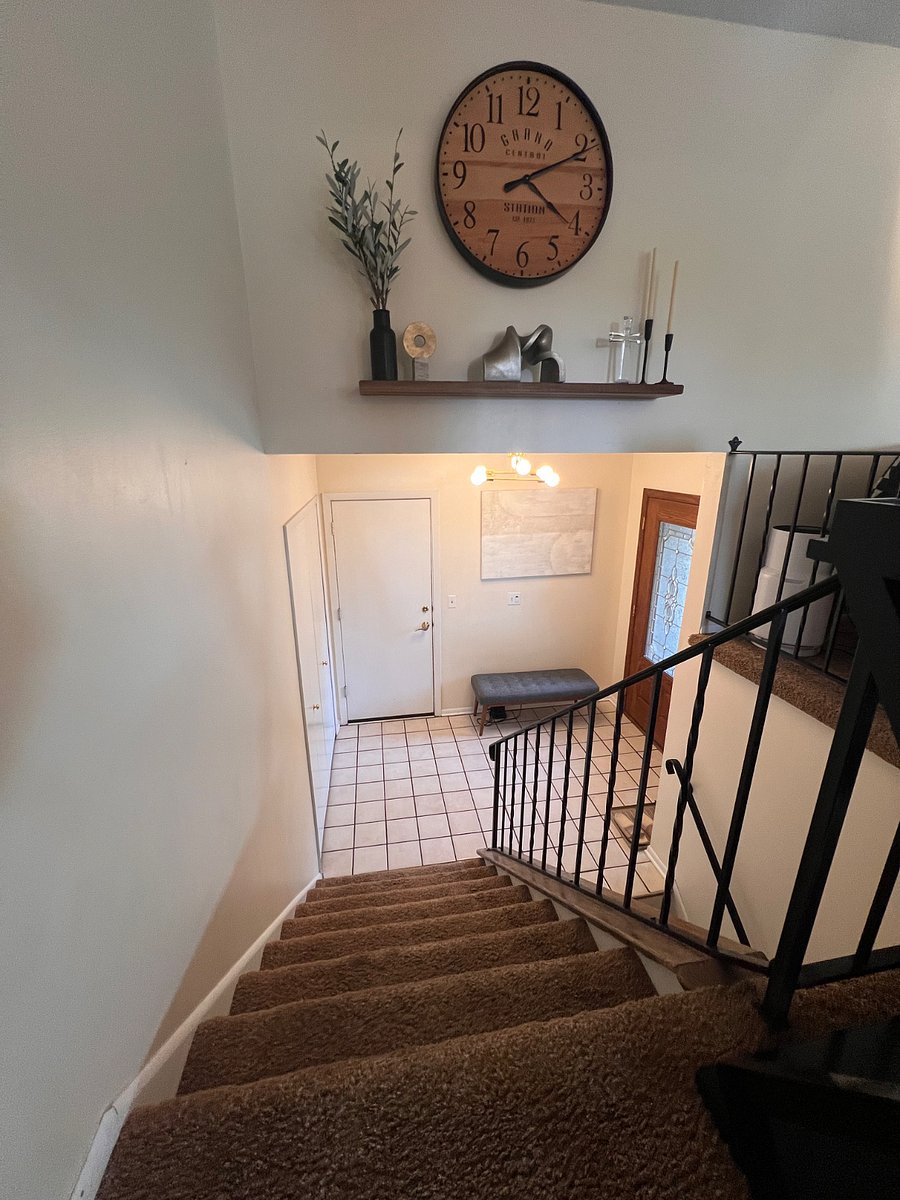 Entry way to upstairs living. Access to 2 stall garage and front patio.