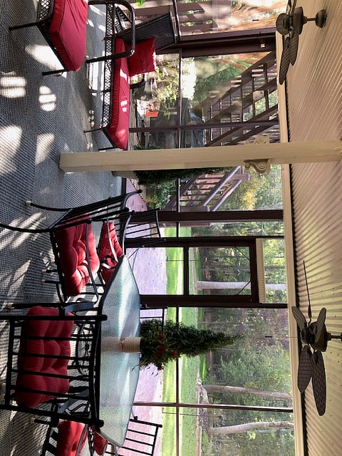 Screened Porch (330 SF) - With outdoor seating and patio view.