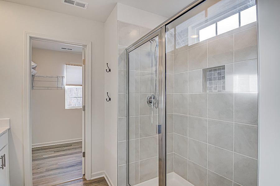Master Suite with walk-in dressing room and bathroom with walk-in shower