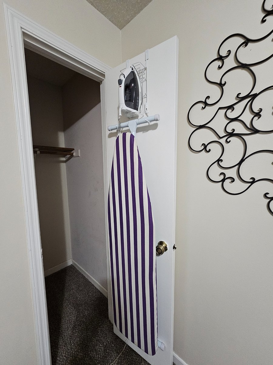 Iron & ironing board in master bedroom second closet
