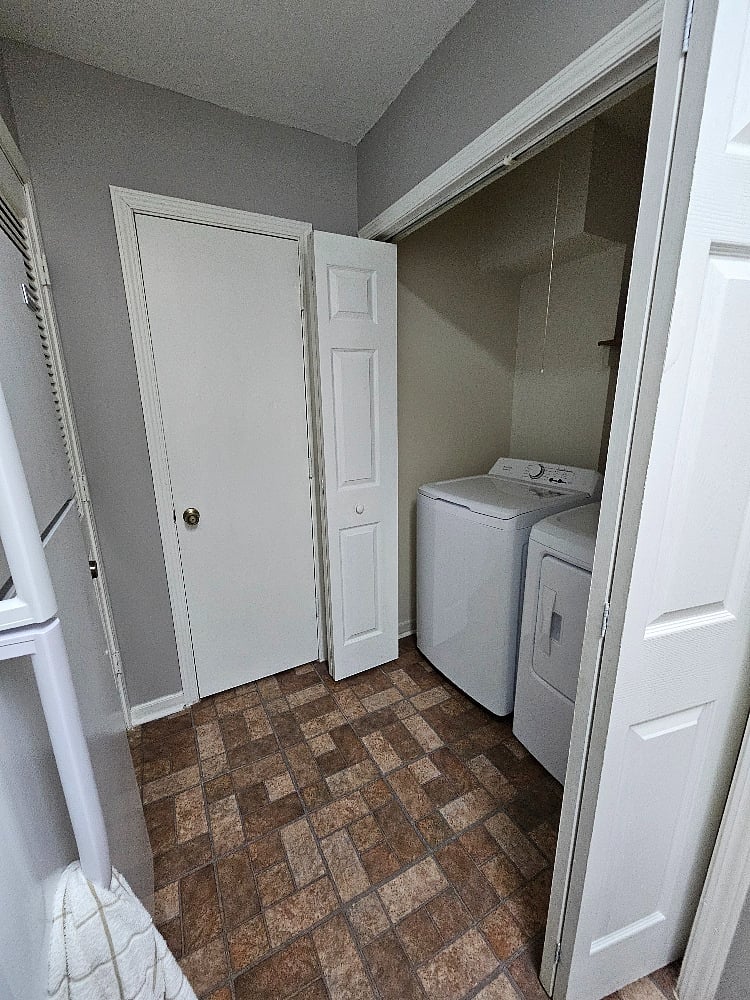 Laundry room w/ separate washer & dryer, located inside the kitchen.