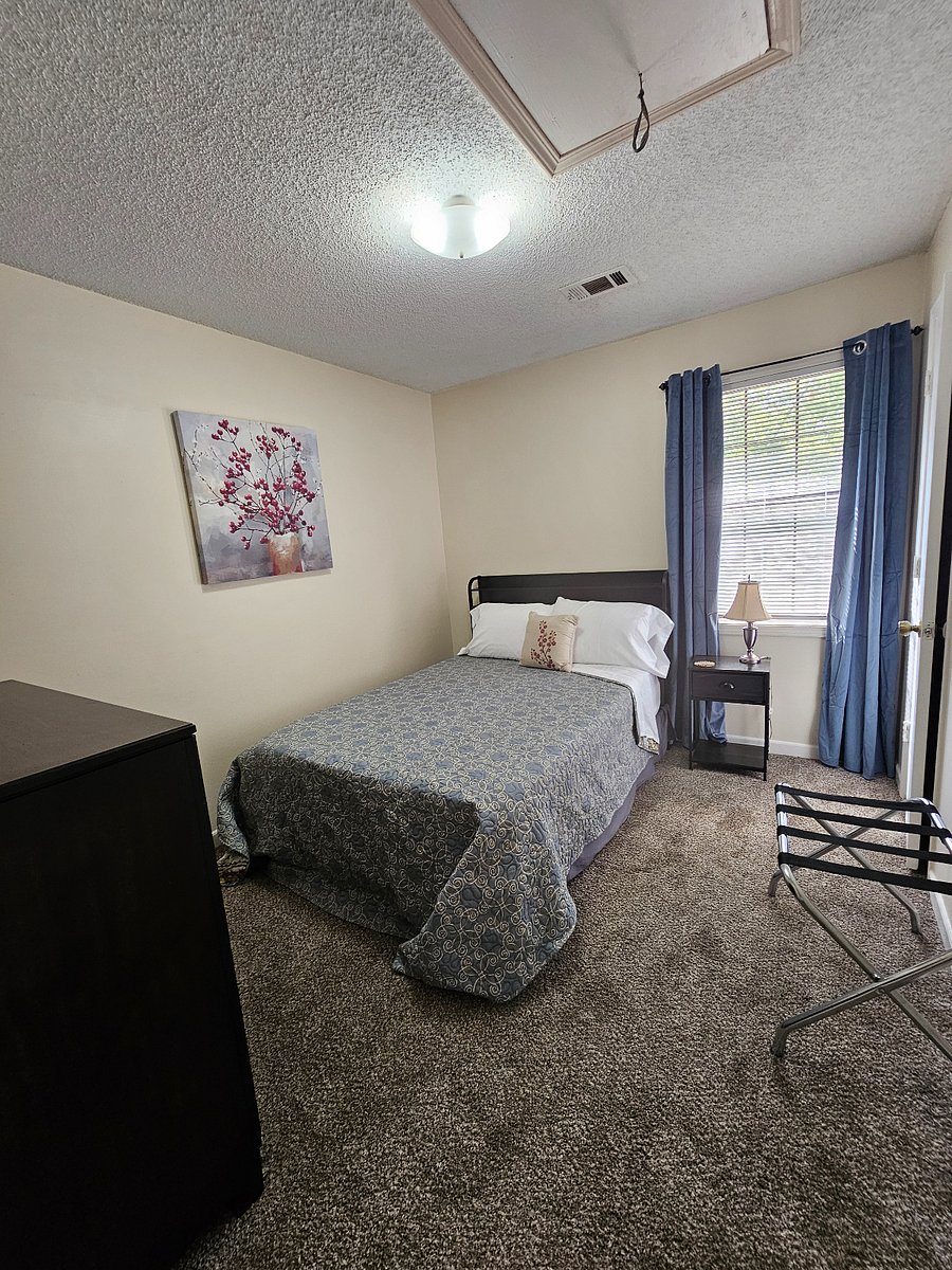 Second bedroom w/ charging ports in the headboard to charge your phone while you sleep.
