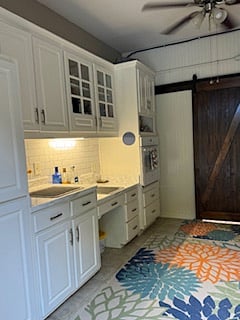 Outdoor Kitchen area, includes oven, refrigerator, outside bath and changing area for pool